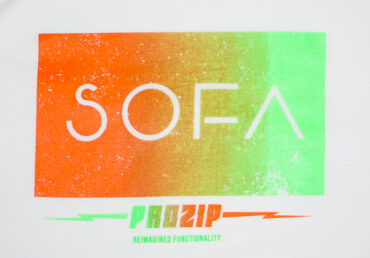 Image of logo on the white SOFA gradient Tee
